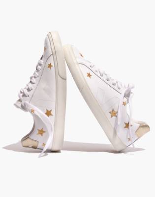 white sneakers with gold stars