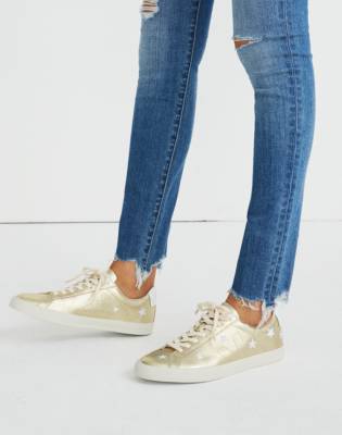 white sneakers with gold stars